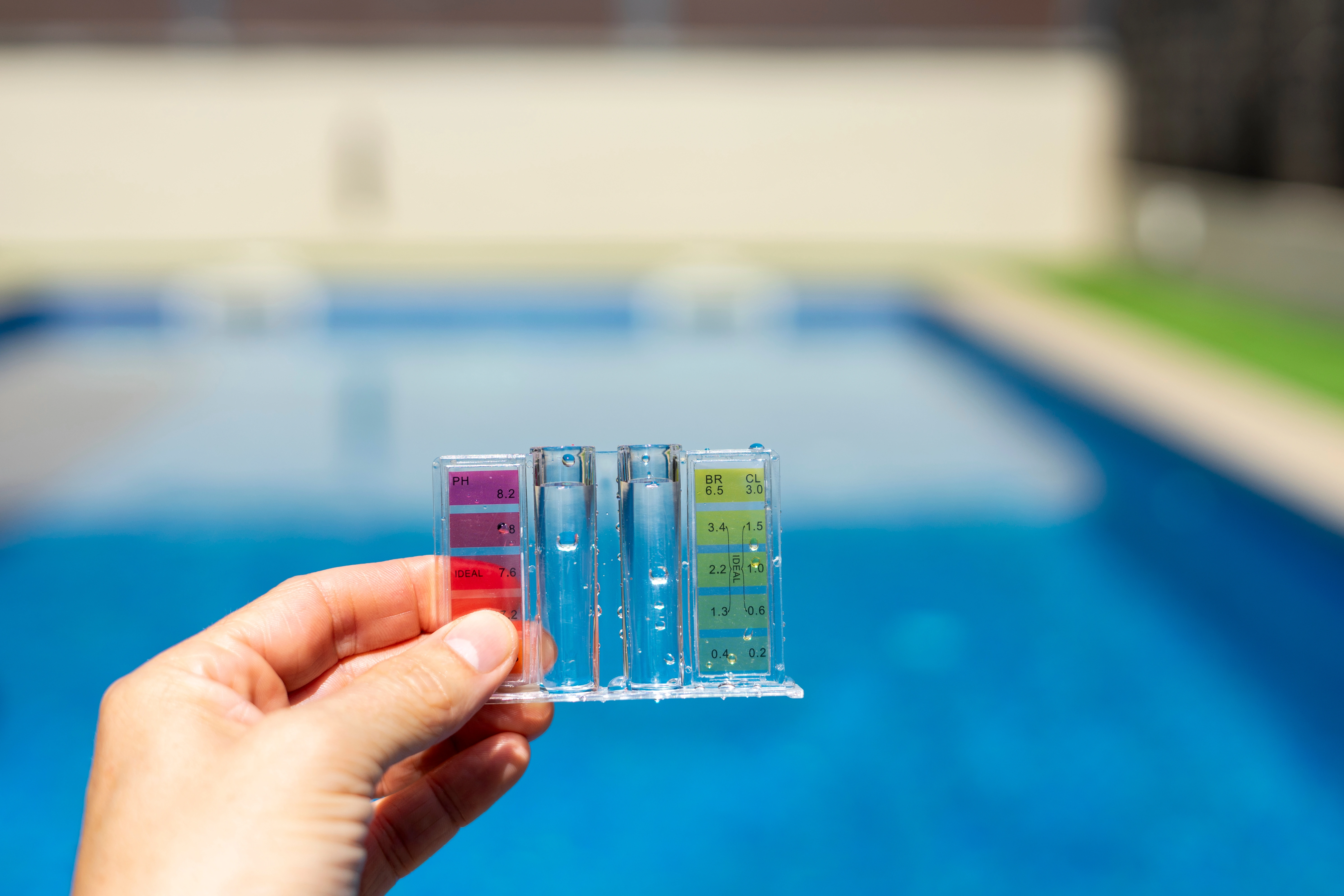 Pool technician testing and adjusting water chemistry for a residential pool